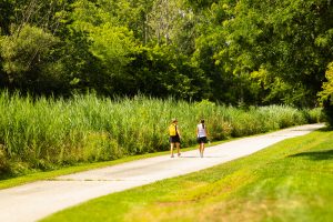 A family walking or cycling on a paved LaSalle trail